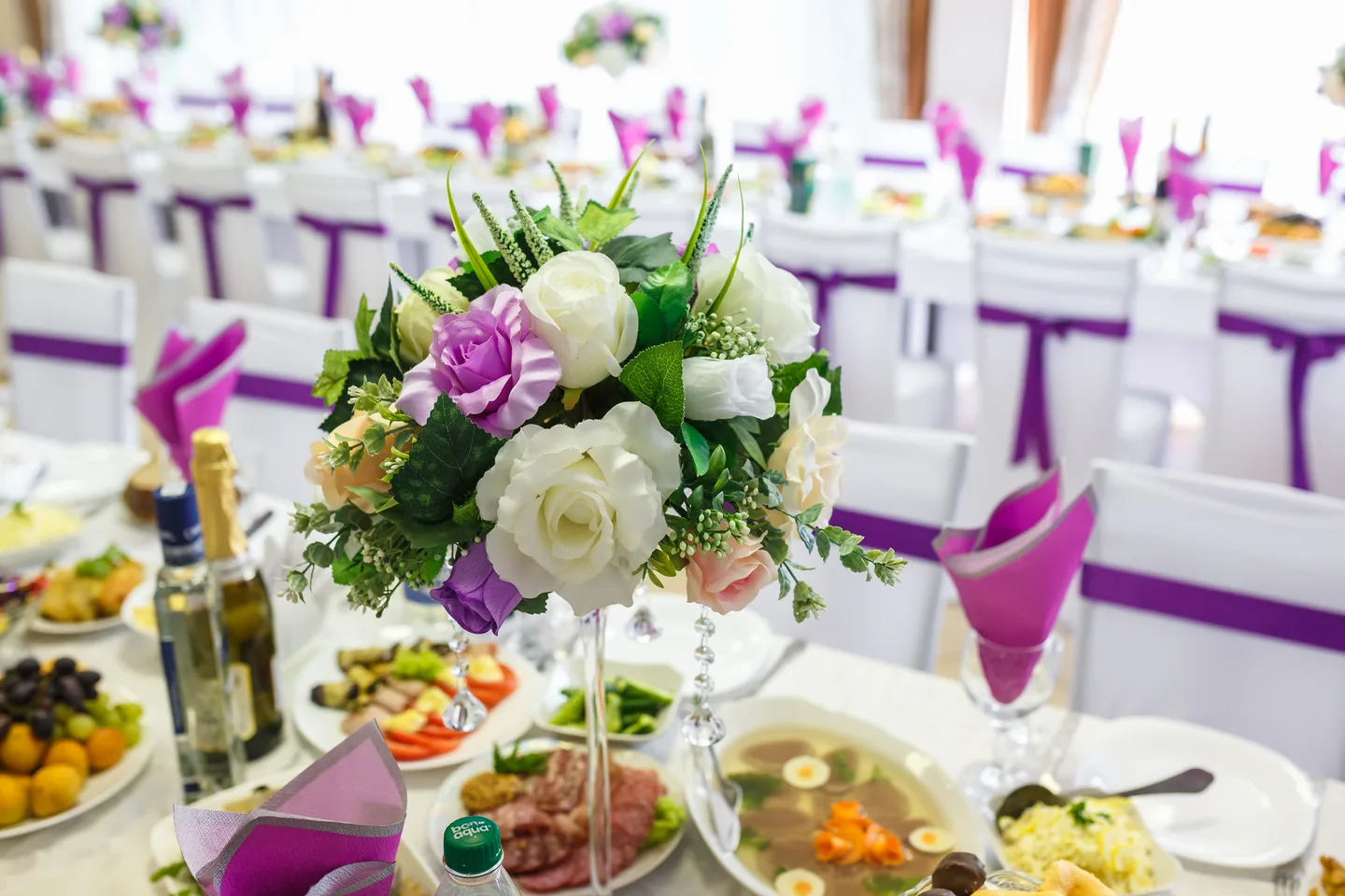 An elegant wedding reception table with a floral centerpiece